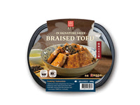 Packaged Braised Tofu in Signature Sauce with Phyllo's line of marinated signature sauces, displayed in a clear container with a label that includes cooking instructions and nutritional information, and placed on a wooden table.