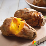 Frozen baked sweet potatoes split open, showing steaming yellow flesh on wooden table—K.K. Orchard Co., LTD. (冰烤番薯 150g.